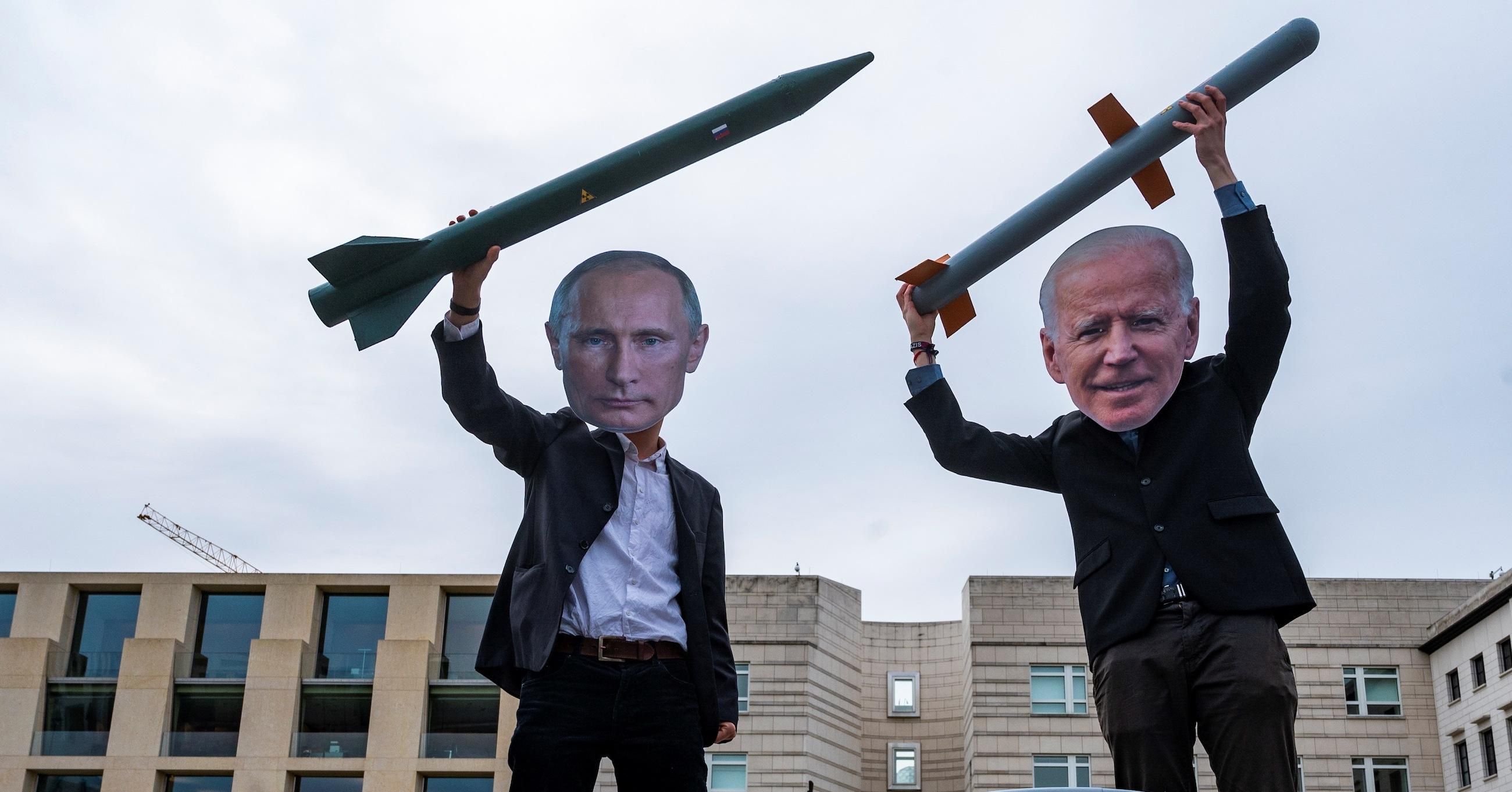 Peace activists wearing masks of Russian President Vladimir Putin (L) and U.S. President Joe Biden pose with mock nuclear missiles in front of the U.S. embassy in Berlin on January 29, 2021 in an action to call for more progress in nuclear disarmament. (Photo: John Macdougall/AFP via Getty Images)