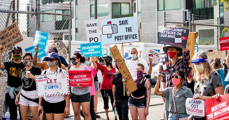 Rally goers gather at a post office to protest the Trump administration's handling of the US Postal System at the Rally to Save the Post Office on August 22, 2020 in Los Angeles, California. 