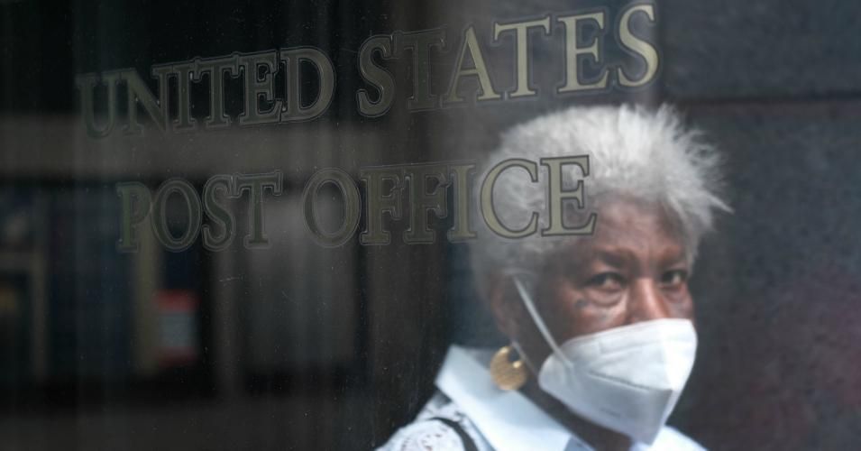 A woman walks into a Brooklyn Post Office on August 05, 2020 in New York City. President Trump in recent weeks has called the Postal Service "a joke" as the agency is experiences delays in mail delivery due to the coronavirus pandemic and financial pressures. (Photo by Spencer Platt/Getty Images)