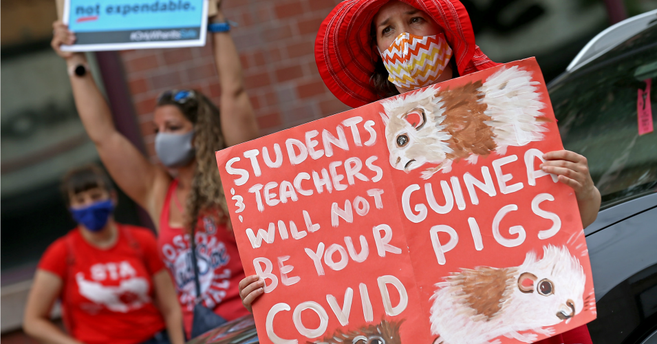 Educators hold up signs during a rally for healthy and safe working and learning conditions in public schools on July 30, 2020 in Malden, Massachusetts. (Photo: Matt Stone/ MediaNews Group/Boston Herald/via Getty images)