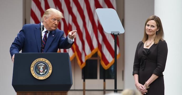 Amy Coney Barrett (R), U.S. President Donald Trump's nominee for associate justice of the U.S. Supreme Court, listens as Trump speaks during an announcement ceremony at the White House on September 26, 2020 in Washington, D.C.