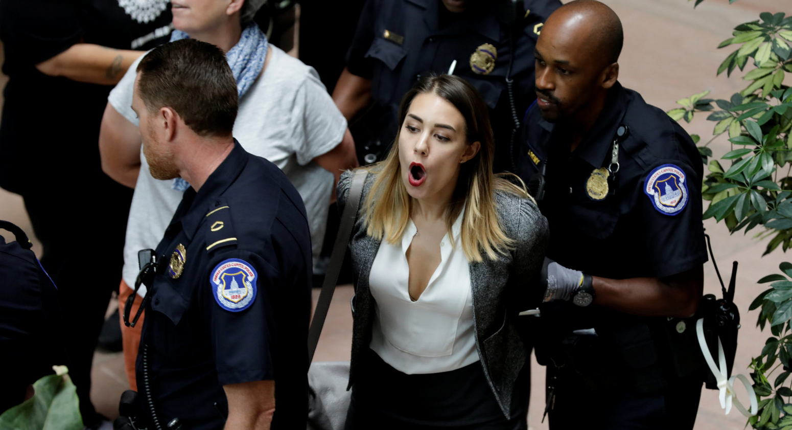 A protester is arrested during a demonstration in opposition to U.S. President Donald Trump’s Supreme Court nominee Brett Kavanaugh on Capitol Hill in Washington, U.S., September 20, 2018. 