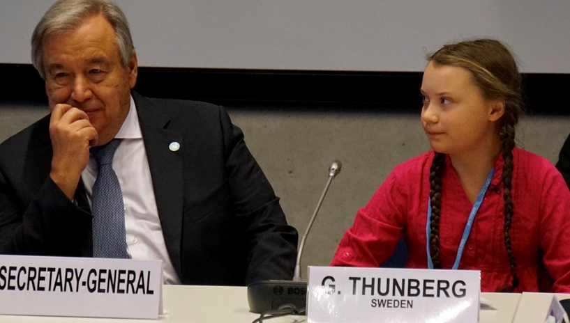 UN Secretary General António Guterres seated next to 15-year-old Swedish climate activist Greta Thunberg, who explained that while the world consumes an estimated 100 million barrels of oil each day, "there are no politics to change that. There are no politics to keep that oil in the ground. So we can longer save the world by playing by the rules, because the rules have to be changed." (Photo: UNFCC COP24 / Screenshot)