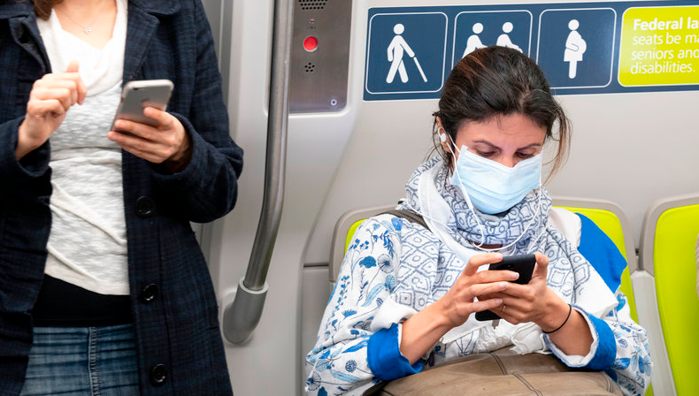 A passenger wears a face mask on a train in San Francisco on Wednesday, February 26, 2020. (Photo: David Paul Morris/Bloomberg via Getty Image) 