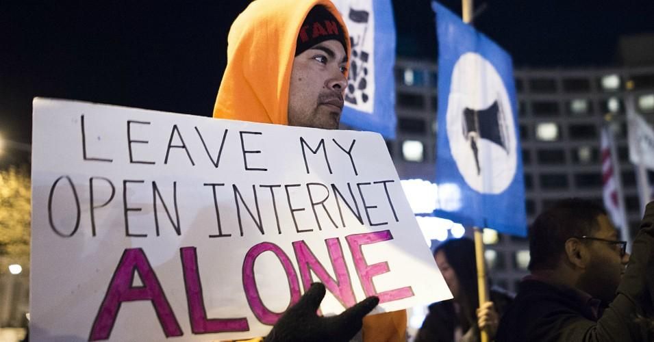 A group of open internet advocates protest then-FCC chair Ajit Pai's net neutrality repeal plan during a demonstration on December 7, 2017 in Washington, D.C.