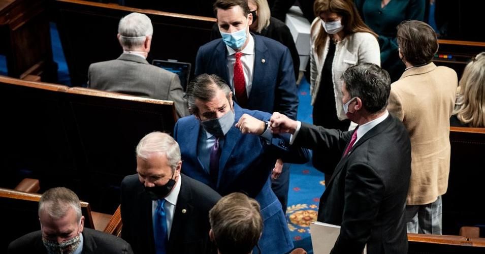 Republican Sens. Ted Cruz (R-Texas; center, fist-bumping) and Josh Hawley (Mo., directly behind Cruz) are being urged to resign for their role in inciting the mob that attacked the U.S. Capitol in Washington, D.C. last week. (Photo: Erin Schaff/AFP via Getty Images)