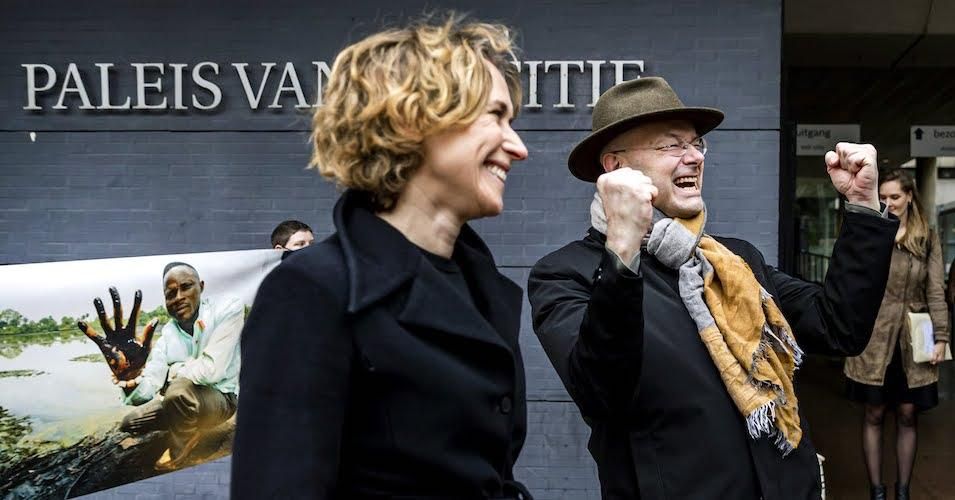 Donald Pols (R), director of Dutch environmental organization Milieudefensie, and Channa Samkalden (L), lawyer for Milieudefensie, react following the court ruling in the case that the organization, along with four Nigerian farmers, filed against Shell over oil leaks that have allegedly polluted their villages, in The Hague, on January 29, 2021.