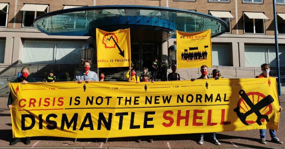 About 30 protesters gathered outside Royal Dutch Shell's headquarters in The Hague Tuesday to declare that the oil giant "must fall."