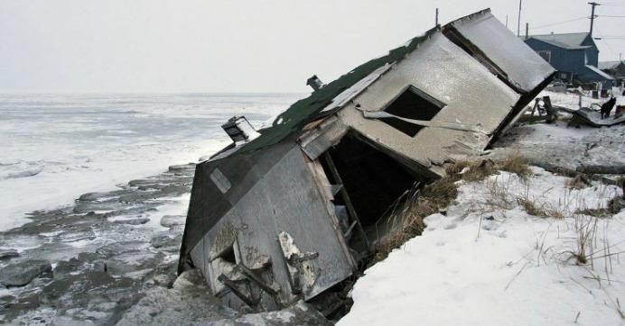 An abandoned house in Shishmaref, Alaska sits on the beach after sliding off during a fall storm in 2005. (Photo: AP Photo/Diana Haecker)