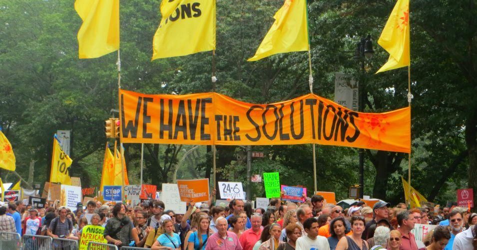 A banner at the 2014 People's Climate March in New York City, during which protesters connected the greed of endless growth with the growing climate crisis. (Photo: UM Women/cc/flickr)
