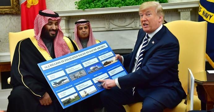 President Donald Trump holds up a chart of military hardware sales as he meets with Crown Prince Mohammed bin Salman of the Kingdom of Saudi Arabia in the Oval Office at the White House on March 20, 2018 in Washington, D.C.