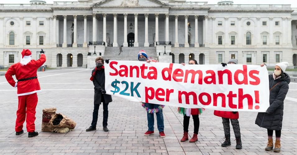 Metro D.C. Socialists protesters demand $2,000 monthly Covid-19 relief checks during a December 25, 2020 demonstration at the U.S. Capitol in Washington, D.C. (Photo: Bill Clark/CQ Roll Call/Getty Images) 
