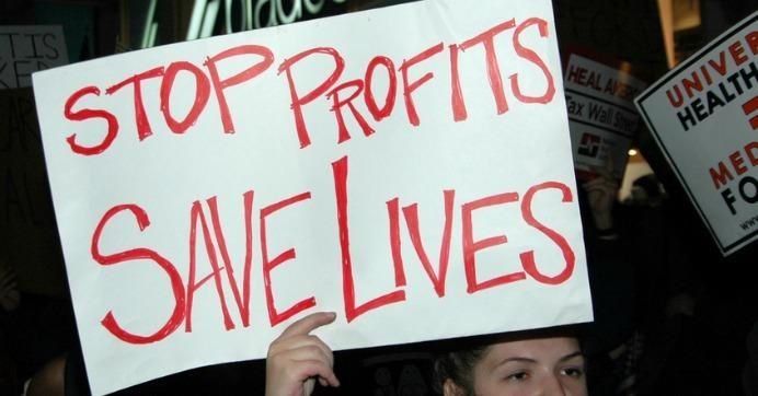 stop profits protest sign