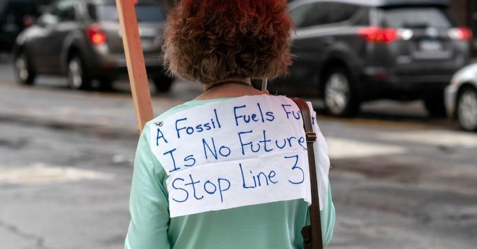 A person's shirt reads: " A fossil fuels future is no future. Stop Line 3."