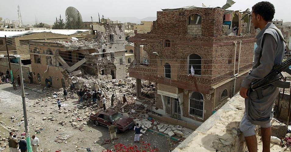 A Houthi rebel looks out at damage caused by a Saudi-led airstrike in the Yemeni capital Sanaa on July 3, 2015. (Photo: Mohammed Huwais/AFP/Getty Images)