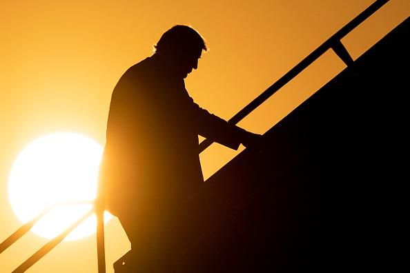 The sun sets on President Donald Trump as he boards Air Force One at Louis Armstrong New Orleans International Airport on May 14, 2019, in Kenner, Louisiana. (Photo: Brendan Smialowski/AFP)