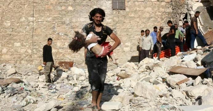 A Syrian man carried a child who was retrieved from a collapsed building following a reported U.S. coalition air strike on the rebel-held neighborhood of Sakhur in the northern city of Aleppo in July 2016. (Photo: Thaer Mohammed/AFP/Getty)