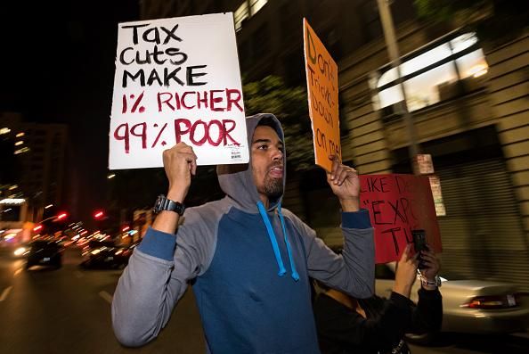 People take part in a protest against the Republican tax bill in Los Angeles, California on December 4, 2017. (Photo: Ronen Tivony/NurPhoto via Getty Images)
