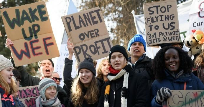 Swedish climate activist Greta Thunberg, Luisa Neubauer, Isabelle Axelsson, and Vanessa Nakate take part in a "Friday for future" youth demonstration in a street of Davos on January 24, 2020