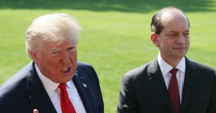 President Donald Trump stands with Labor Secretary Alex Acosta, who announced his resignation, while talking to the media at the White House on July 12, 2019 