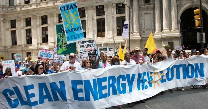 Marchers in Philadelphia carry a sign reading Clean Energy Revolution