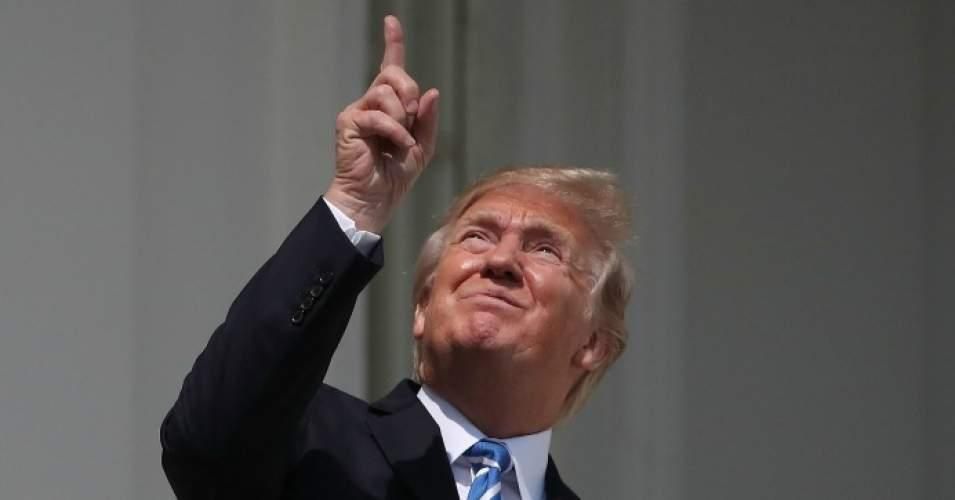 President Donald Trump looks up toward the solar eclipse without protective eyewear