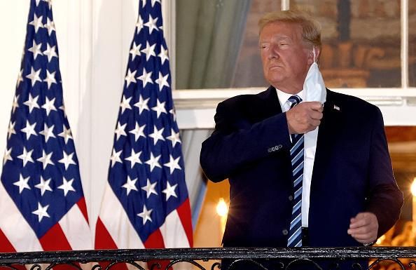 U.S. President Donald Trump removes his mask on October 5, 2020, upon return to the White House from Walter Reed National Military Medical Center, where he had been hospitalized after contracting Covid-19. (Photo: Win McNamee/Getty Images)