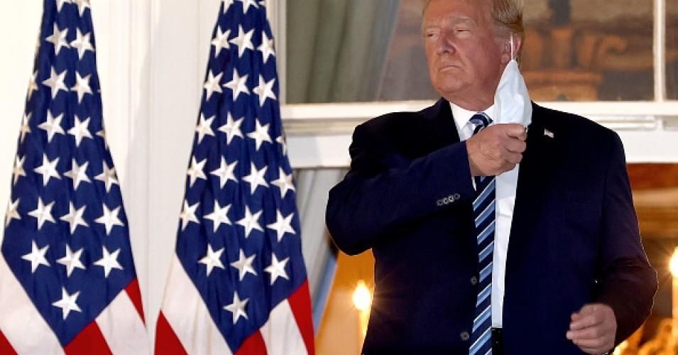 Then-President Donald Trump removed his mask on October 5, 2020, upon return to the White House from Walter Reed National Military Medical Center, where he had been hospitalized after contracting Covid-19. (Photo: Win McNamee/Getty Images)