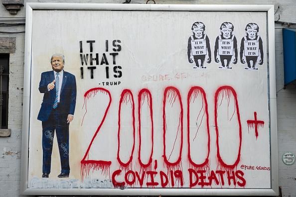 Street art that reads, "200,000+ Covid-19 deaths" next to an "It is what it is" quote by President Donald Trump is displayed on a wall in New York City on September 29, 2020. (Photo: Alexi Rosenfeld/Getty Images)