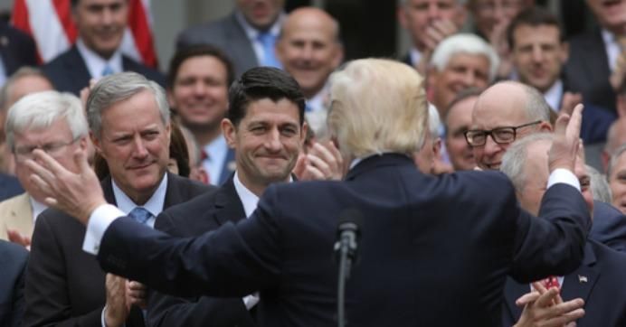 President Donald Trump embraces loyal GOP representatives in the White House Rose Garden following the U.S. House passage of Trumpcare. (Photo: Reuters)