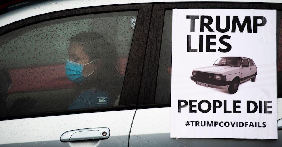 Protesters prepare to lead a "People's Motorcade" past the White House to deliver fake body bags to the Trump International Hotel on April 23, 2020.