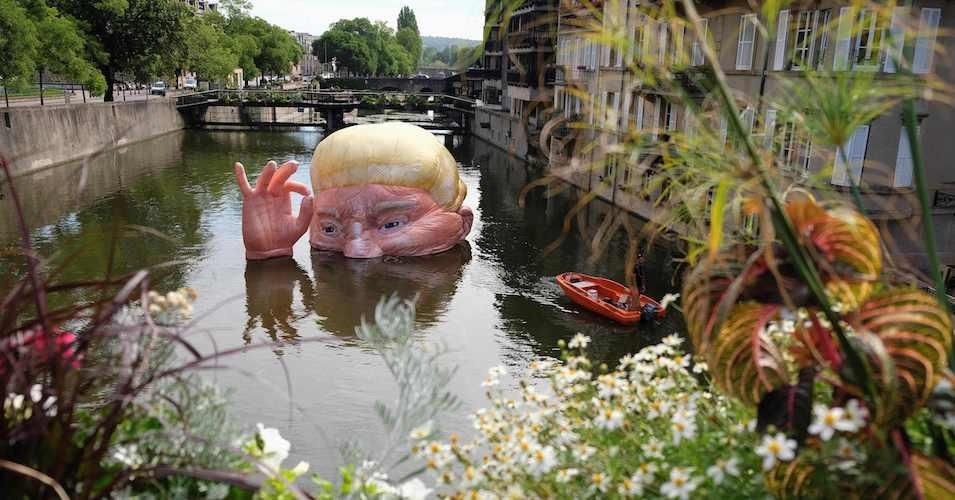 A picture taken on July 5, 2019 shows the installation "Everything is fine" depicting the half submerged head of US President Donald Trump by Jacques Rival, architect, displayed in the Moselle river as part of the digital art festival "Constellations de Metz" in Metz, eastern France. 