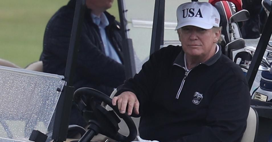 US President Donald Trump drives a golf buggy on his golf course at the Trump Turnberry resort in June 2019. 