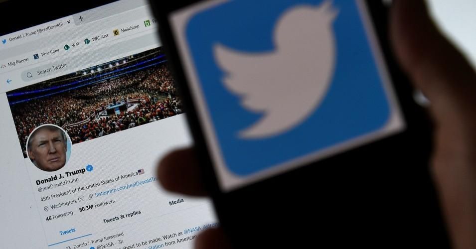 In this photo illustration, a Twitter logo is displayed on a mobile phone with President Donald Trump's Twitter page shown in the background on May 27, 2020, in Arlington, Virginia. (Photo: Olivier Douliery/AFP via Getty Images)
