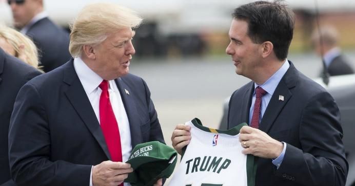 President Donald Trump holds a hat given to him by Wisconsin Gov. Scott Walker upon his arrival in Kenosha on April 18, 2017. (Photo: Saul Loeb/AFP/Getty Images)