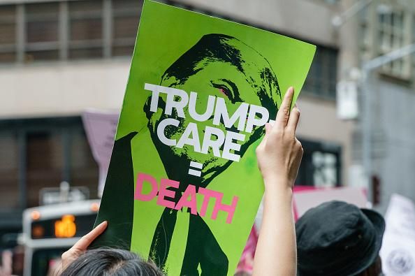 Participants hold signs while protesting efforts made by President Donald Trump and Republican legislators to the repeal the Affordable Care Act at a demonstration in New York City on July 29, 2017. (Photo: Albin Lohr-Jones/Pacific Press/LightRocket via Getty Images)