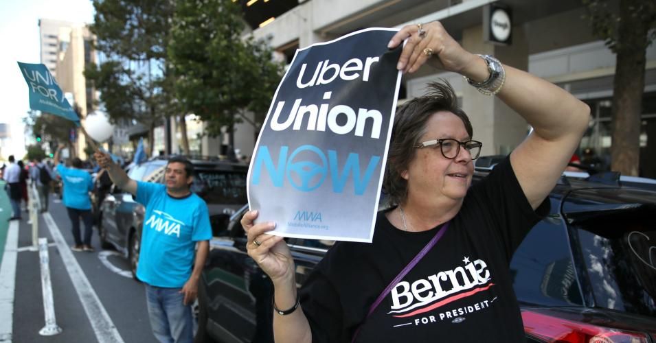 Rideshare drivers hold signs during a protest outside of Uber headquarters on August 27, 2019 in San Francisco, California. Dozens of Uber and Lyft drivers staged a protest outside of Uber headquarters in support of California assembly bill 5 and to organize a union for rideshare drivers. (Photo: Justin Sullivan/Getty Images)