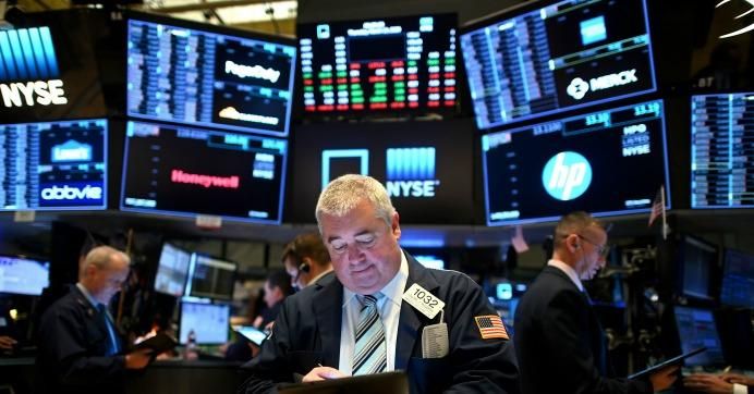 Traders work during the opening bell at the New York Stock Exchange (NYSE) on March 19, 2020, at Wall Street in New York City.