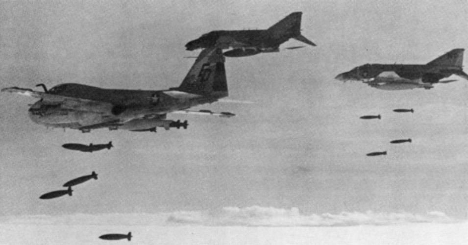 U.S. fighter jets and an attack plane drop bombs on Cambodia circa 1973. 
