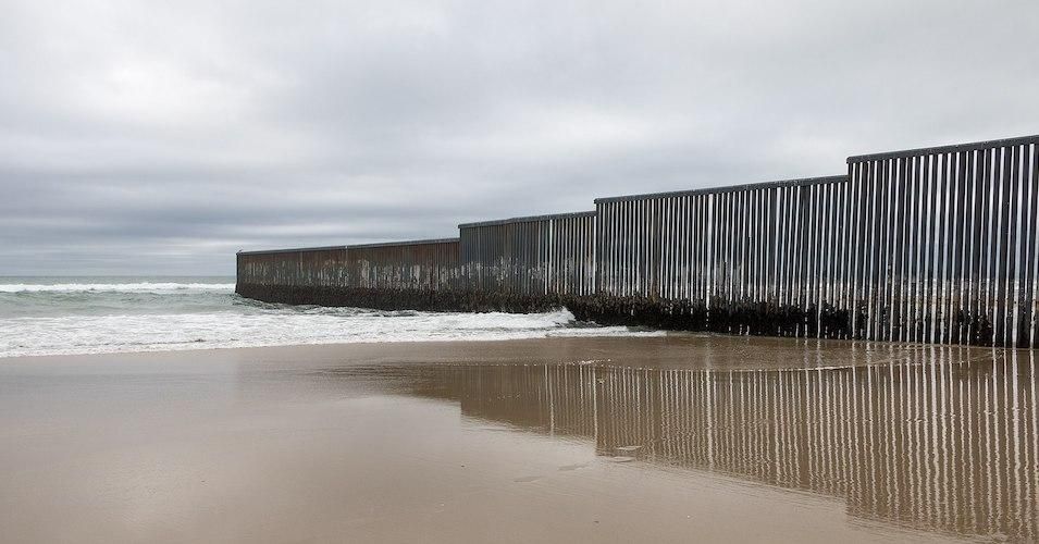 A section of the border wall ending in the Pacific Ocean in San Diego–Tijuana.