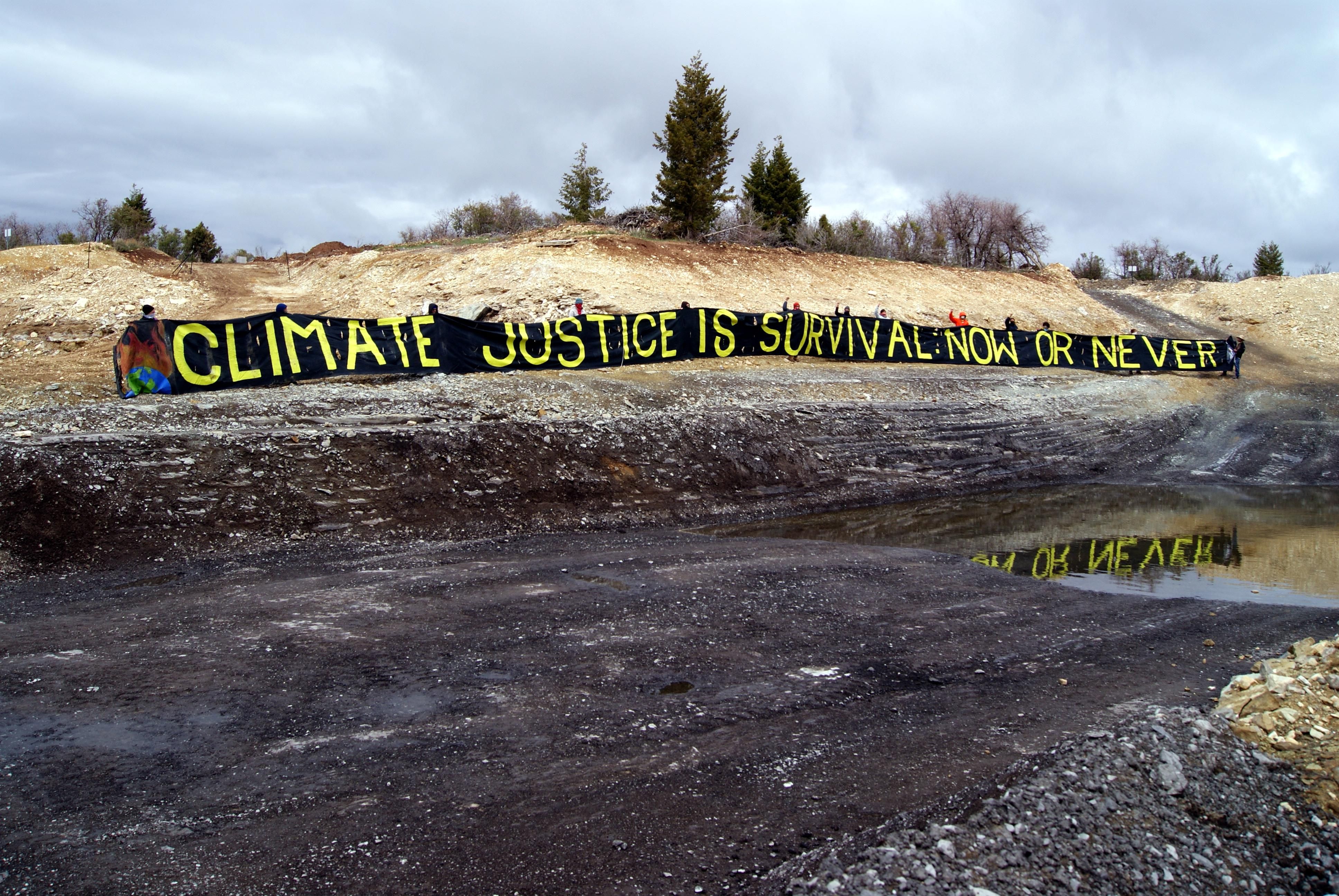 A banner unfurled at the Utah tar sands site earlier this year. (Photo: Utah Tar Sands Resistance)