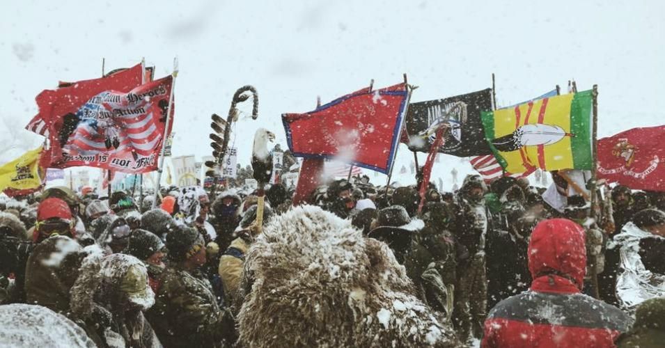 Veterans and water protectors unite in prayer, calling for an end to the entire Dakota Access Pipeline project, in the midst of a blizzard Monday. 
