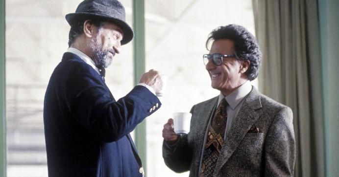 Dustin Hoffman and Robert De Niro appear in the 1997 film "Wag the Dog," about a political consultant and a Hollywood director who construct a fake war with Albania to distract the population from a sex scandal days ahead before a presidential election. (Screenshot via Phillip Caruso/www.phillipcaruso.com)