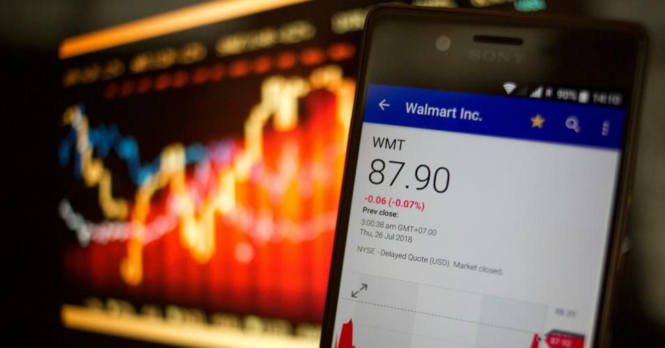 In this photo illustration, a smartphone displays the Walmart Inc. market value on the stock exchange via the Yahoo Finance app.