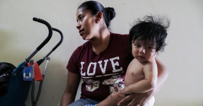 A Guatemalan mother and her baby boy, 8 months, both asylum seekers, sit in a shelter for migrants who are seeking asylum on May 17, 2019 in Las Cruces, New Mexico.