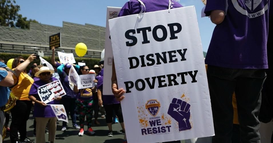 Disneyland workers and supporters rally while protesting low pay and calling for a living wage at the Disneyland entrance on July 3, 2018 in Anaheim, California