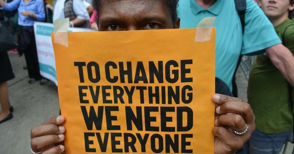 Sign reads: To change everything we need everyone