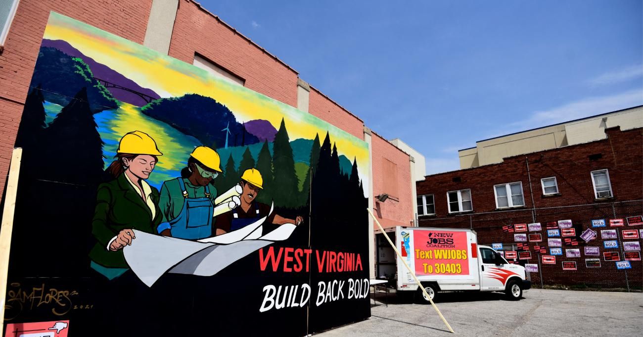 A mural painted by Sam Flores is introduced during a community gathering and job fair as West Virginians take action for an economic recovery and infrastructure package prioritizing climate, care, jobs, justice and call on Congress to pass the THRIVE Act on April 08, 2021 in Charleston, West Virginia. (Photo by Emilee Chinn/Getty Images for Green New Deal Network)