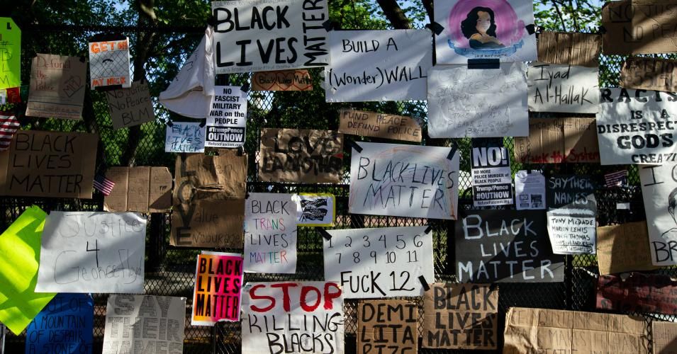 Signs are left in front of the White House's recently erected security fence now turned into a memorial against police brutality and the death of George Floyd, during a peaceful protest on June 7, 2020 in Washington, DC. (Photo: Jose Luis Magana/AFP via Getty Images)
