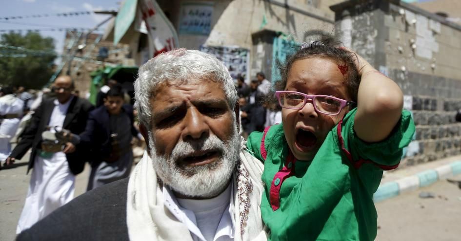 An injured girl carried by a man out of a mosque that was attacked by a suicide bomber in Sanaa, Yemen, on March 20, 2015. (Photo: Khaled Abdullah/Reuters)